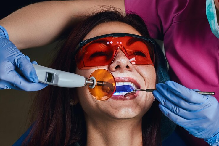 female-dentist-treating-patient-close-up-photo-young-woman-sitting-dentist-s-chair_613910-17777